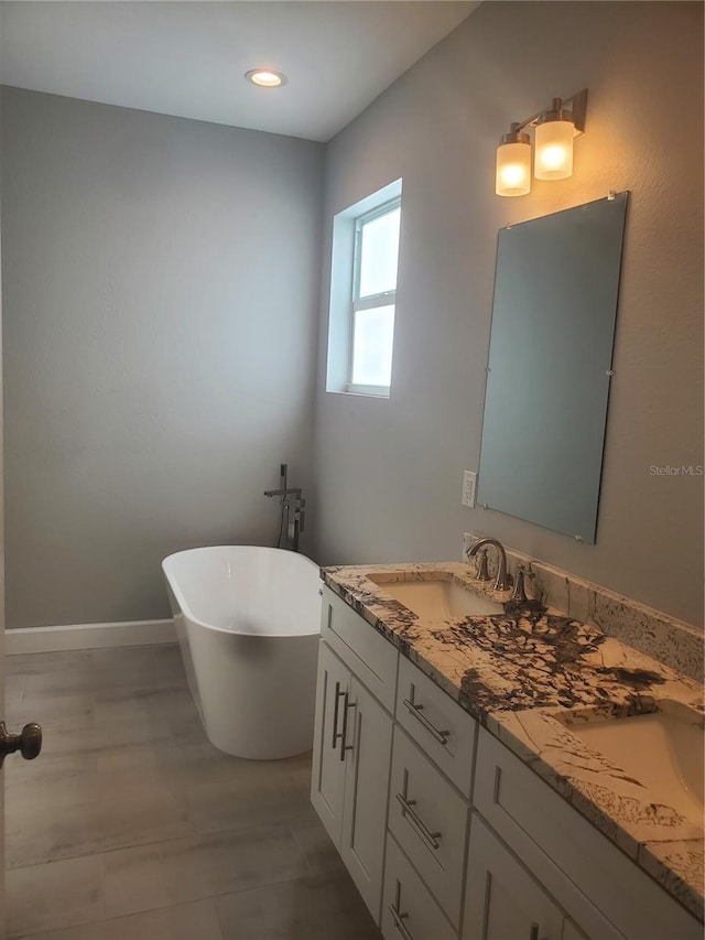 bathroom featuring a bath and double vanity