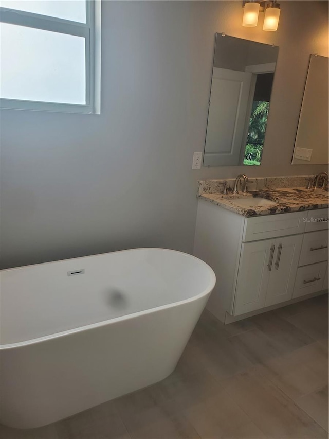 full bathroom with vanity and a soaking tub