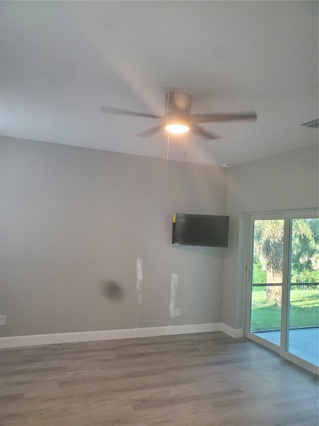 spare room with wood-type flooring and ceiling fan