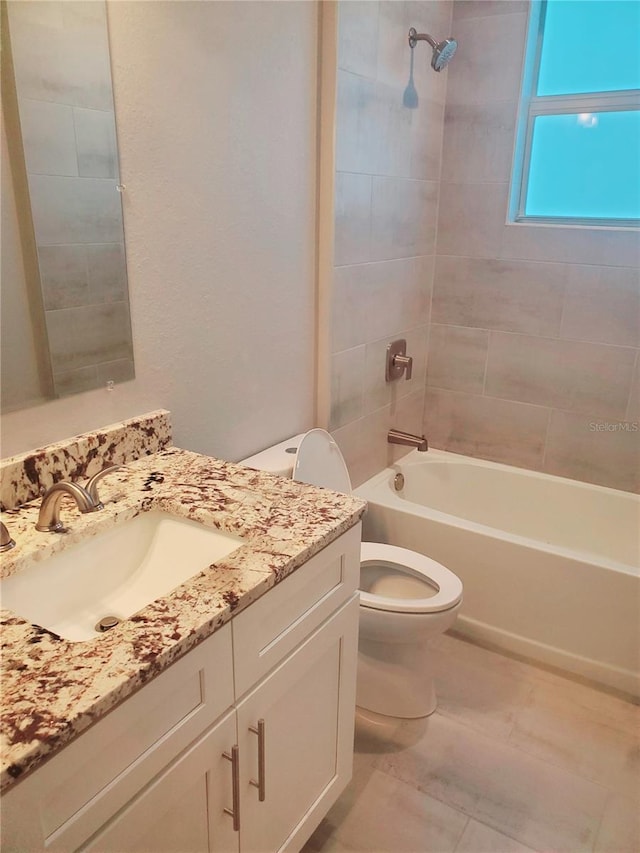 bathroom with vanity, bathing tub / shower combination, and toilet