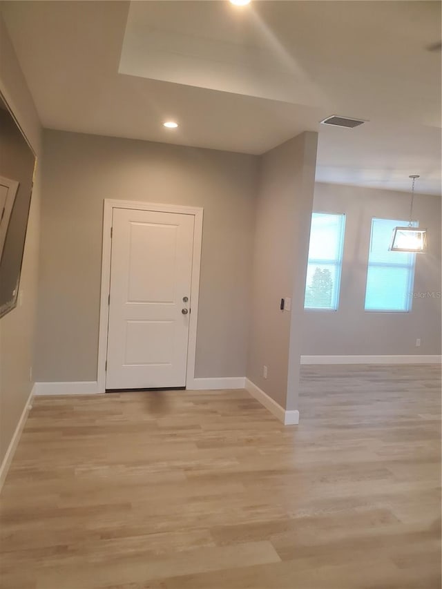 foyer entrance with light wood-style flooring, recessed lighting, visible vents, and baseboards