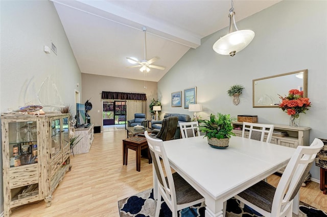 dining area featuring beam ceiling, high vaulted ceiling, ceiling fan, and light hardwood / wood-style flooring