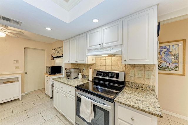 kitchen featuring stainless steel electric range oven, ceiling fan, light tile floors, white cabinets, and tasteful backsplash