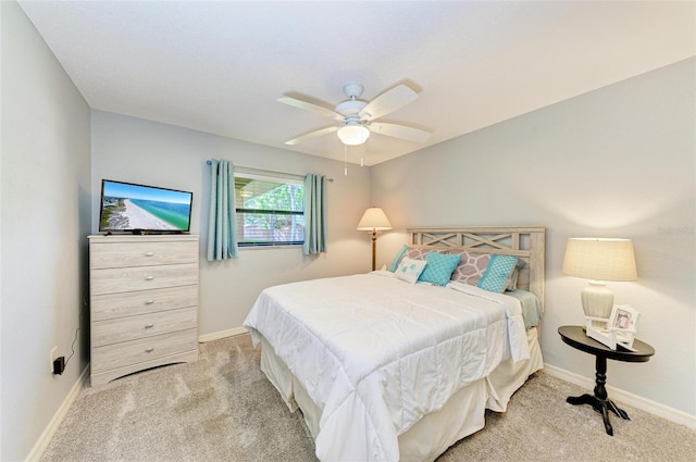 bedroom with light carpet and ceiling fan