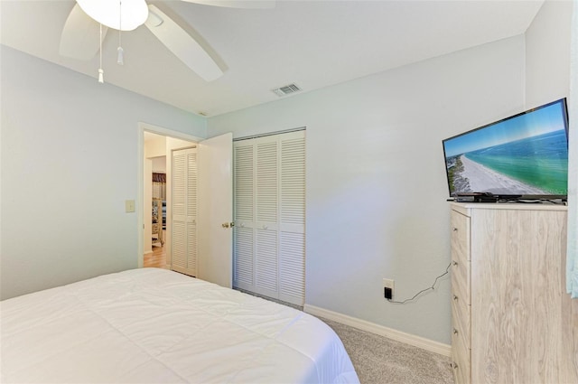 carpeted bedroom with a closet and ceiling fan