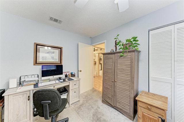 office with light colored carpet, ceiling fan, and a textured ceiling