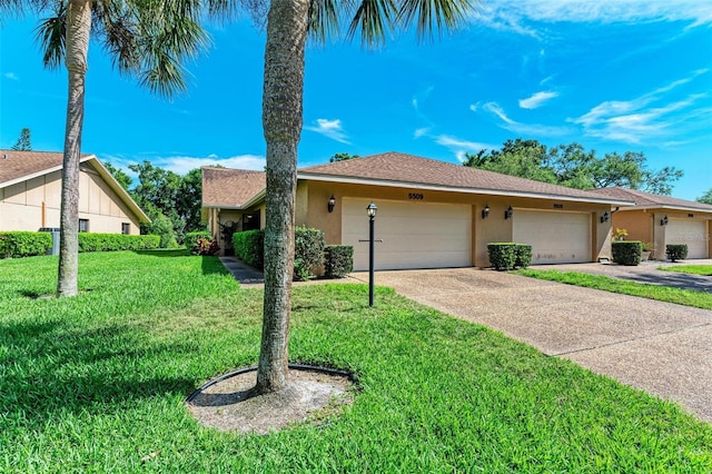 ranch-style home with a front yard and a garage