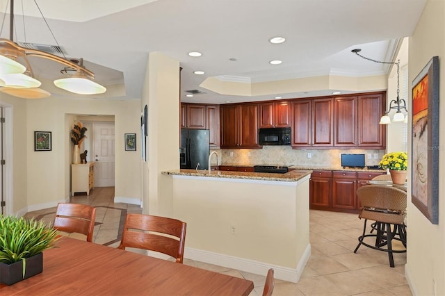 kitchen with backsplash, black appliances, crown molding, decorative light fixtures, and light stone counters