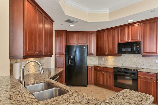 kitchen with light stone countertops, tasteful backsplash, crown molding, sink, and black appliances