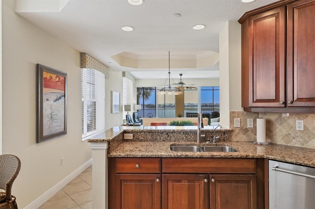 kitchen with light stone counters, ceiling fan, crown molding, and sink