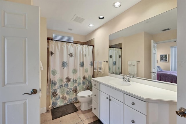 bathroom featuring tile patterned flooring, vanity, and toilet