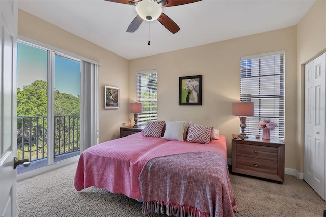 bedroom with ceiling fan, light colored carpet, access to outside, and a closet