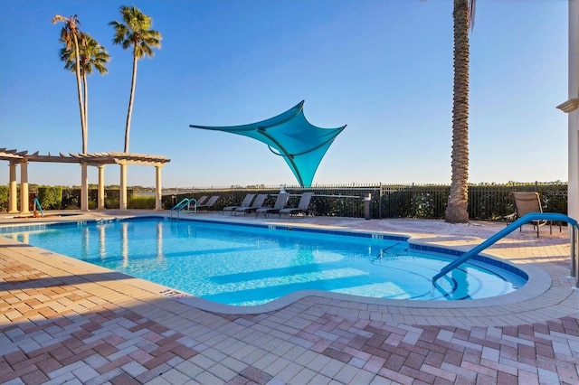 view of swimming pool featuring a pergola and a patio