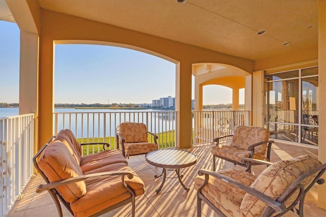 exterior space featuring a water view and a balcony