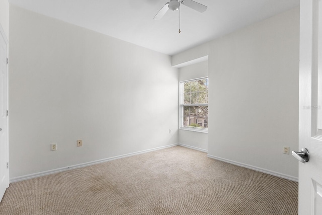 unfurnished room featuring ceiling fan and light carpet