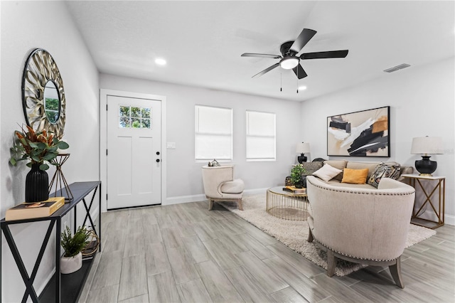 living room featuring light wood-type flooring and ceiling fan