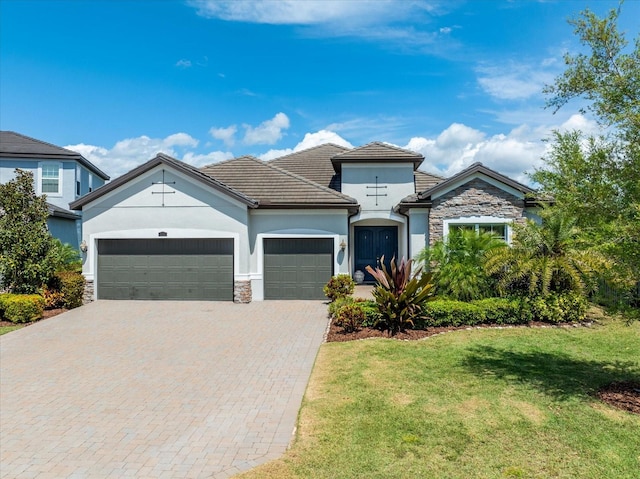 view of front facade with a garage and a front lawn