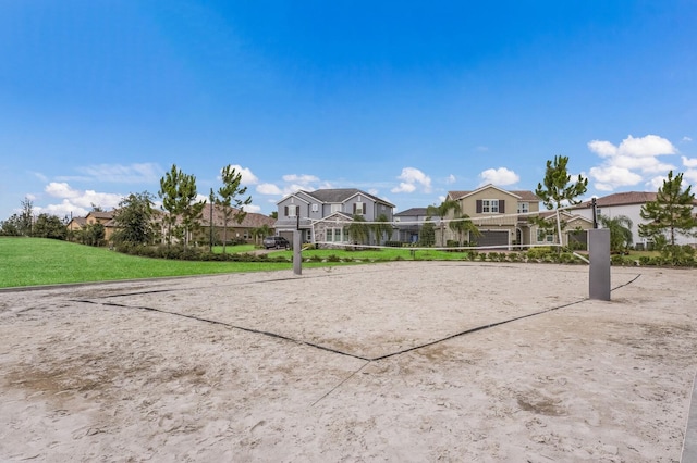 view of home's community featuring volleyball court and a lawn