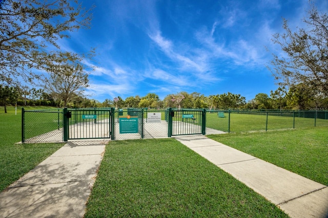 view of gate with a yard