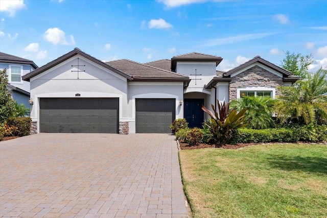 view of front facade with a front yard and a garage