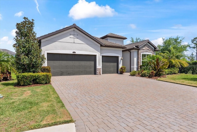 view of front of house with a front yard and a garage