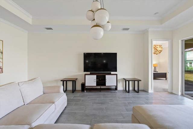 living room featuring a raised ceiling and crown molding