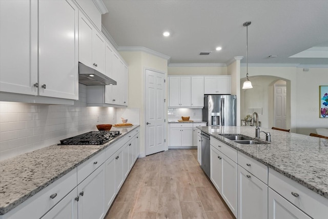 kitchen with sink, ornamental molding, appliances with stainless steel finishes, decorative light fixtures, and white cabinetry