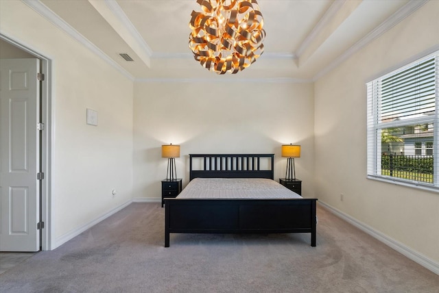 carpeted bedroom featuring a tray ceiling, crown molding, and a chandelier