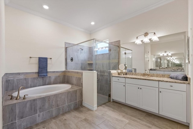 bathroom featuring shower with separate bathtub, vanity, and ornamental molding