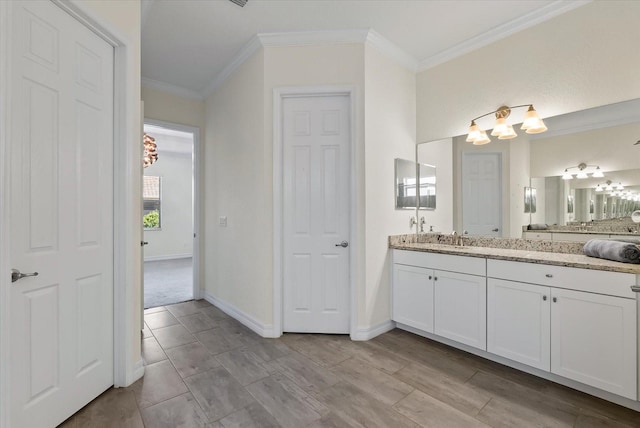 bathroom with vanity and ornamental molding