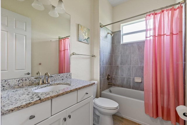 full bathroom with vanity, shower / bath combo, and toilet