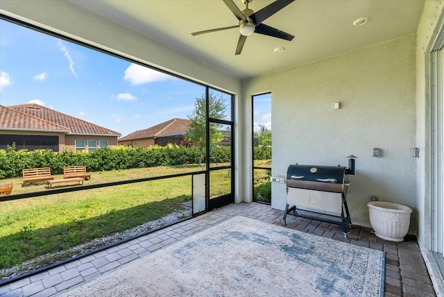 sunroom / solarium featuring ceiling fan