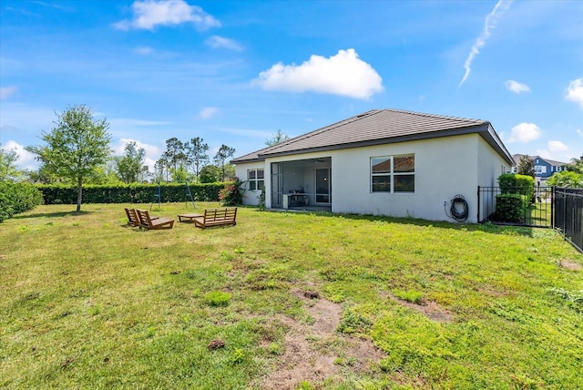 back of house featuring a lawn