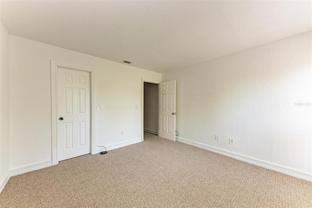 unfurnished bedroom with light colored carpet