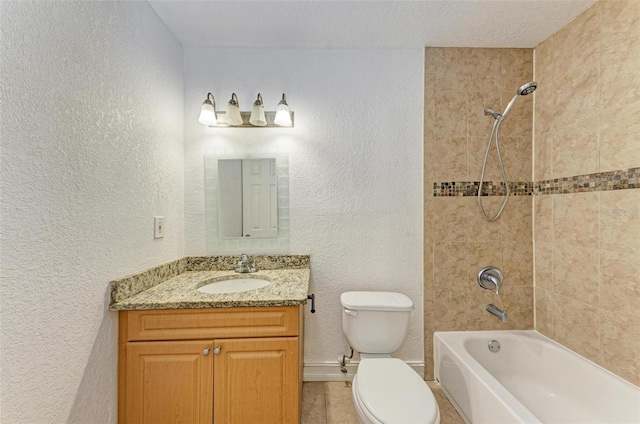 full bathroom featuring toilet, a textured ceiling, vanity, tiled shower / bath, and tile floors