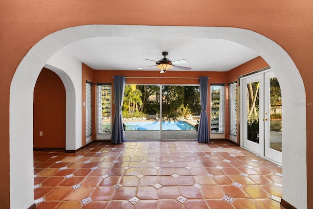 unfurnished room with french doors, tile flooring, a textured ceiling, and ceiling fan