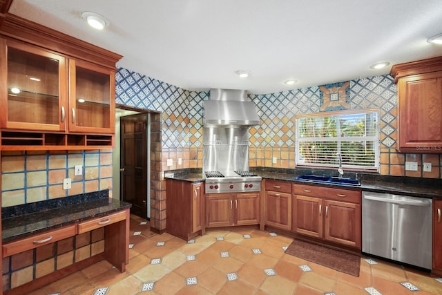 kitchen with appliances with stainless steel finishes, sink, light tile floors, dark stone counters, and tasteful backsplash