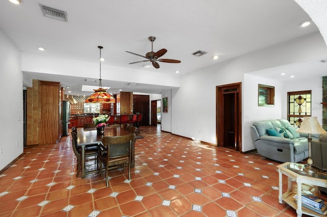 tiled dining room with ceiling fan