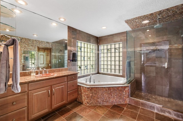 bathroom featuring shower with separate bathtub, tile floors, and vanity with extensive cabinet space