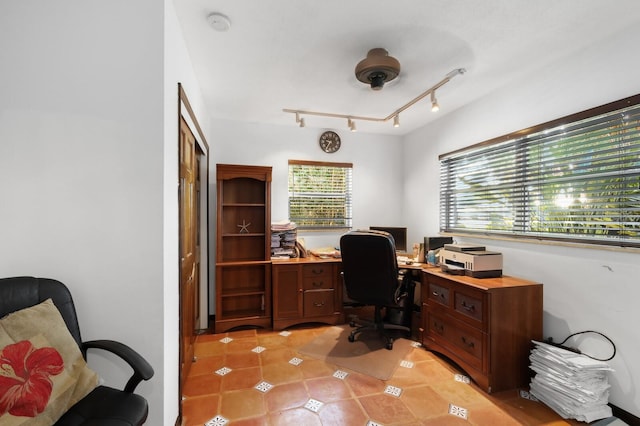 office space with light tile floors and track lighting