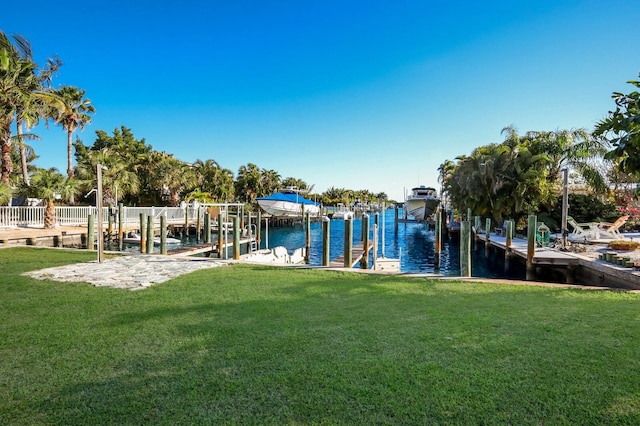 view of yard with a water view and a boat dock