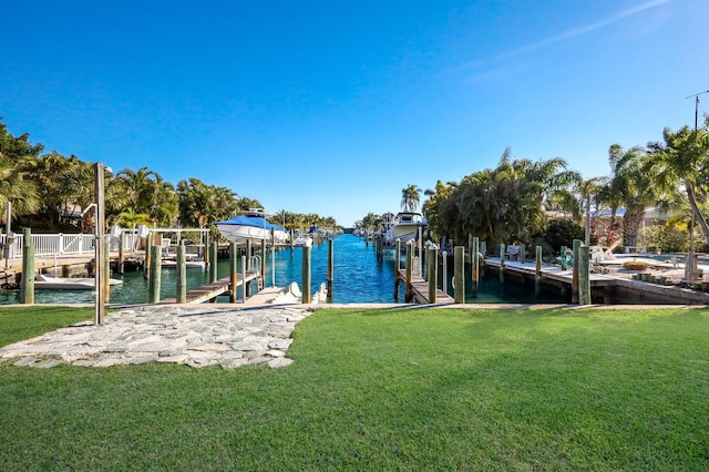 dock area featuring a lawn and a water view