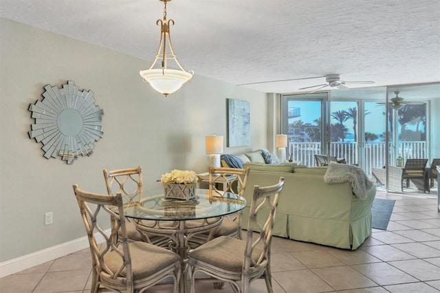 dining area with ceiling fan, a textured ceiling, and light tile flooring