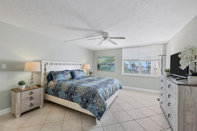 tiled bedroom featuring ceiling fan and a textured ceiling