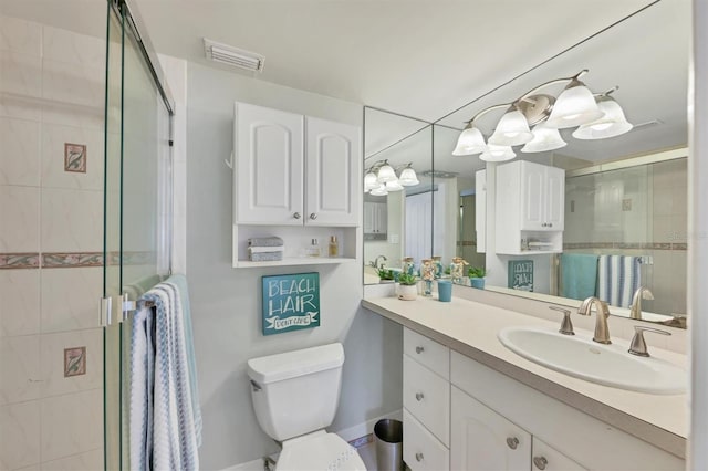 bathroom with an enclosed shower, oversized vanity, and toilet