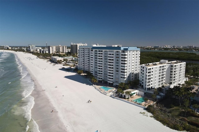 drone / aerial view with a beach view and a water view