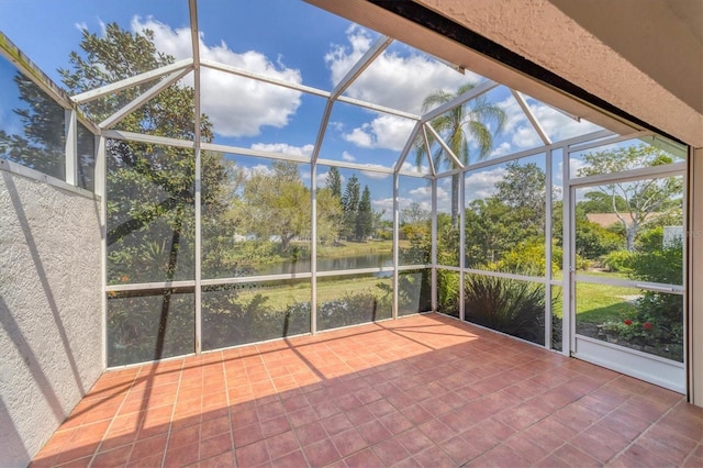 unfurnished sunroom with a water view