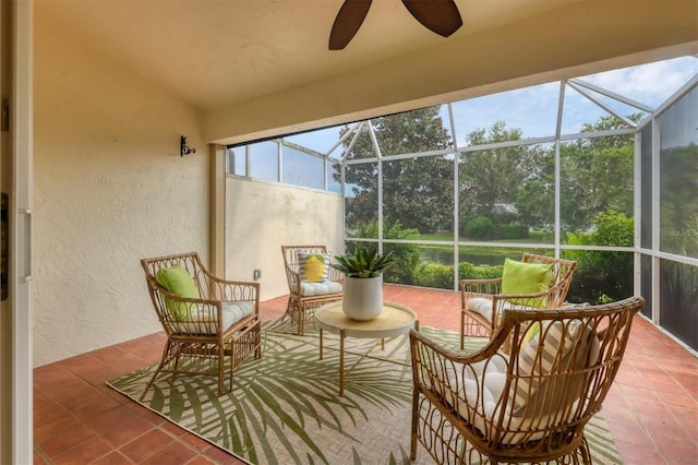 sunroom with ceiling fan, plenty of natural light, and vaulted ceiling