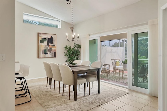 dining area featuring light tile patterned floors, a chandelier, and vaulted ceiling