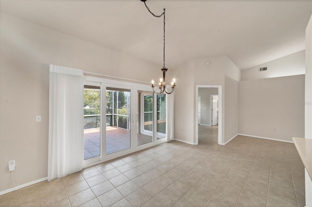 empty room with light tile patterned floors, a chandelier, and vaulted ceiling